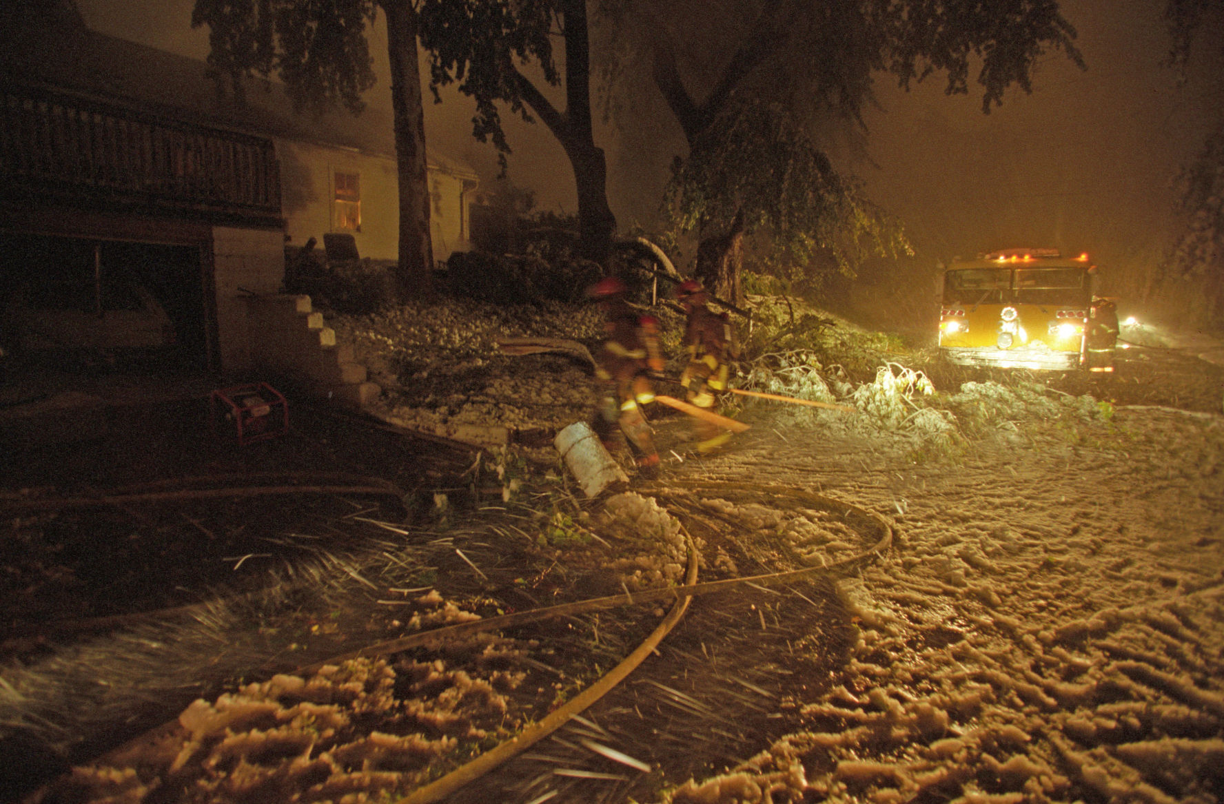 Emergency vehicles had a hard time getting to their calls. Here a fire truck tries to get past the wires and trees near the house.